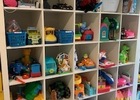 Two of four shelves filled with many toys