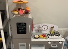 The play kitchen with table and loads of pretend food